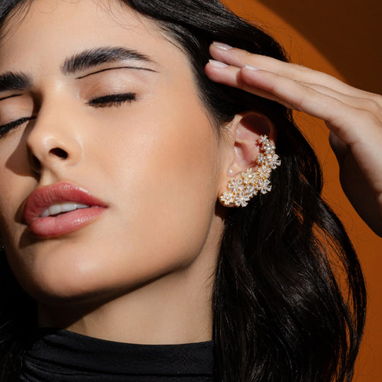 Modelo usando brinco flores dourado com acabamento em ouro 18k